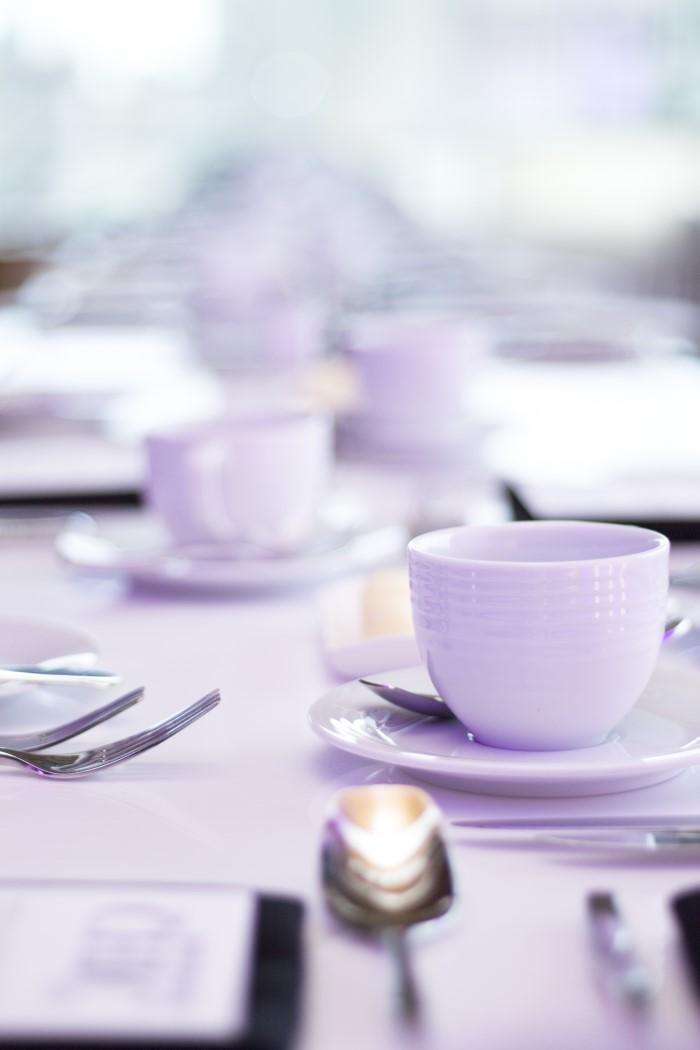Table with coffee cup and cutlery.