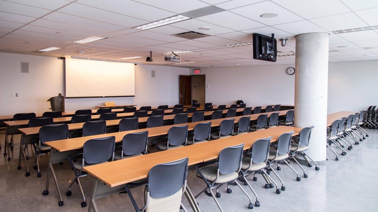 Desmarais 12110 room with desks, chairs and projector.