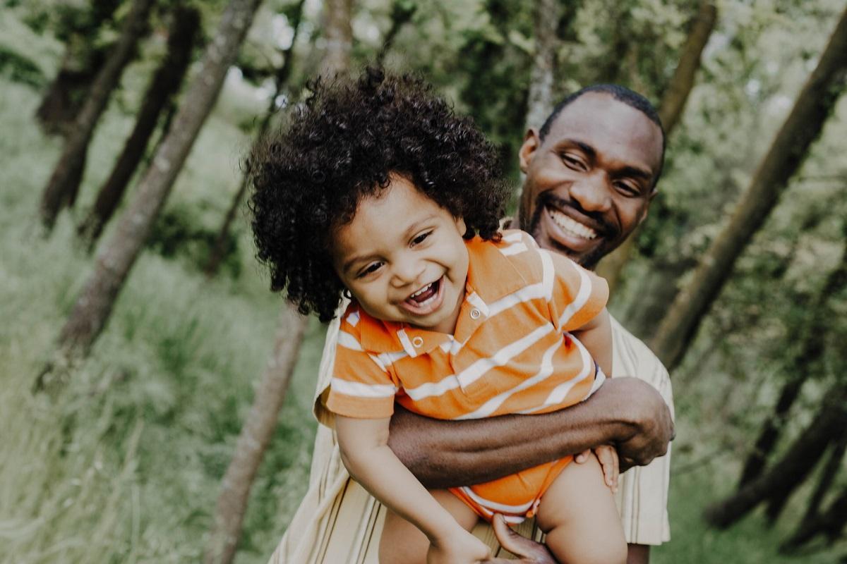 Father and baby son laughing