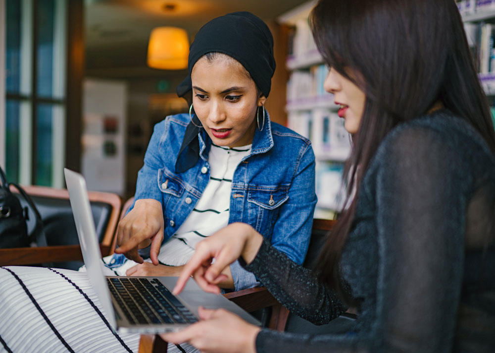 two people working on a computer