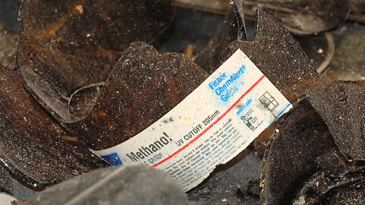 broken brown glass with safety label