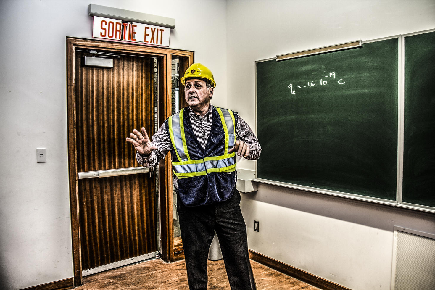 Man wearing a yellow hardhat in classroom