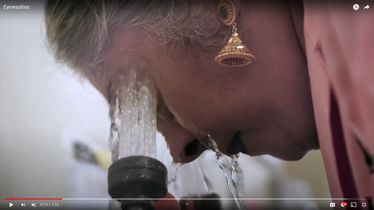 lab worker using eyewashing station