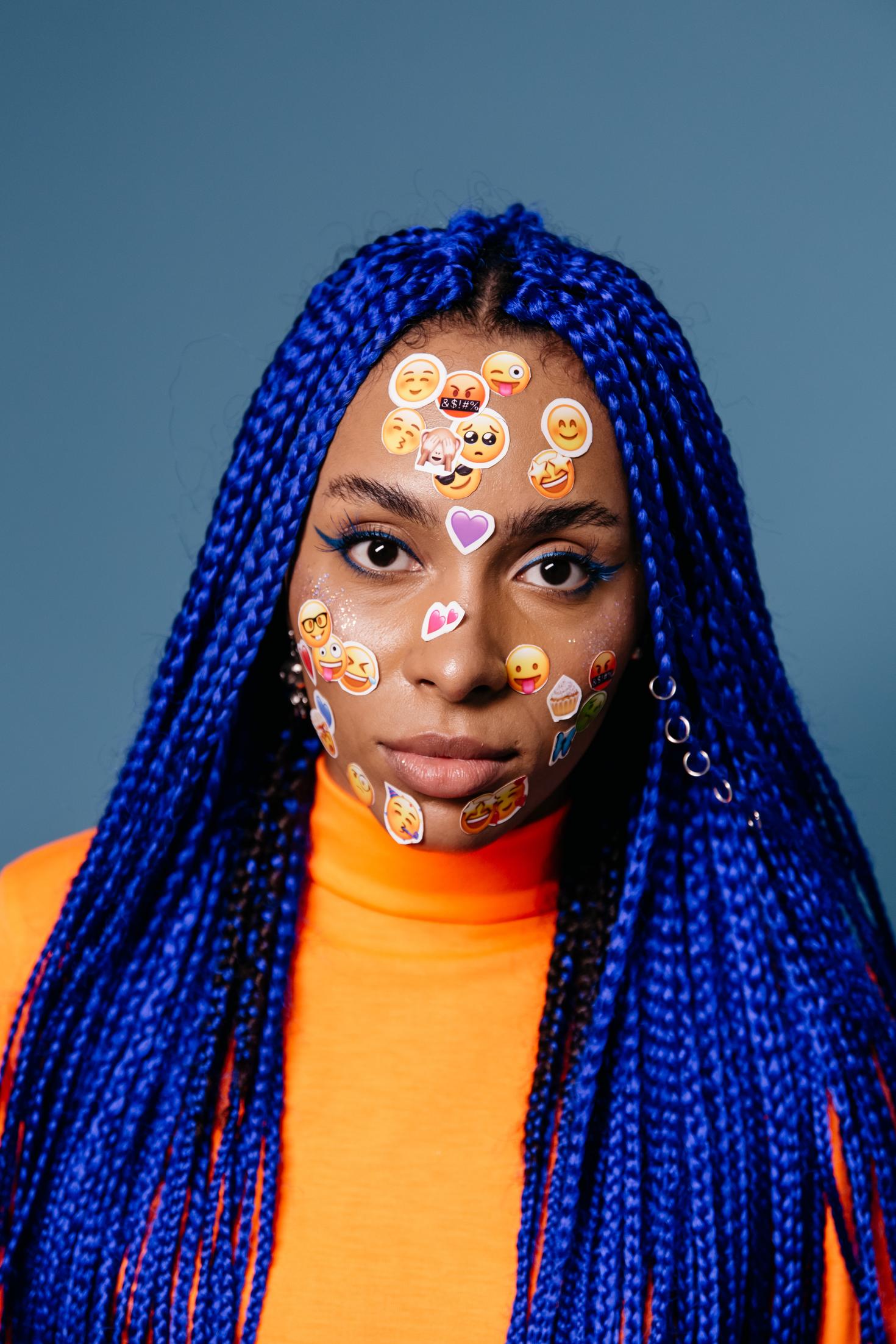 Girl with emojis stickers on her face
