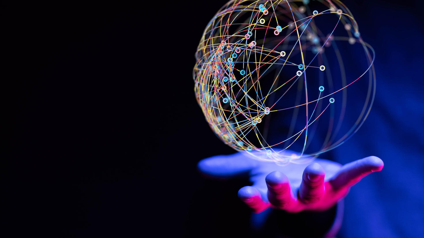 Hand holding a sphere that represents connections.
