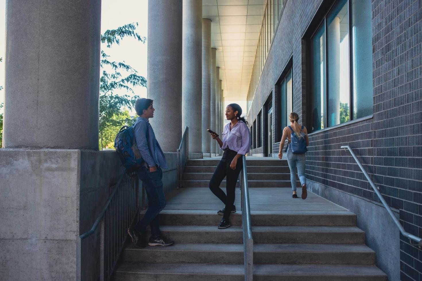 students talking in stairwell
