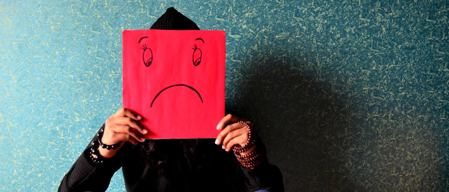 Adolescent expressing sadness.