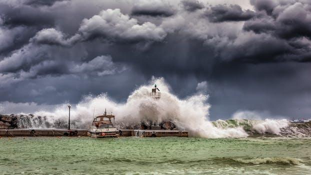 Picture of waves crashing under stormy sky