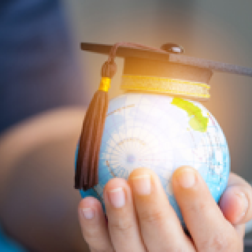 world globe with a hat in hand