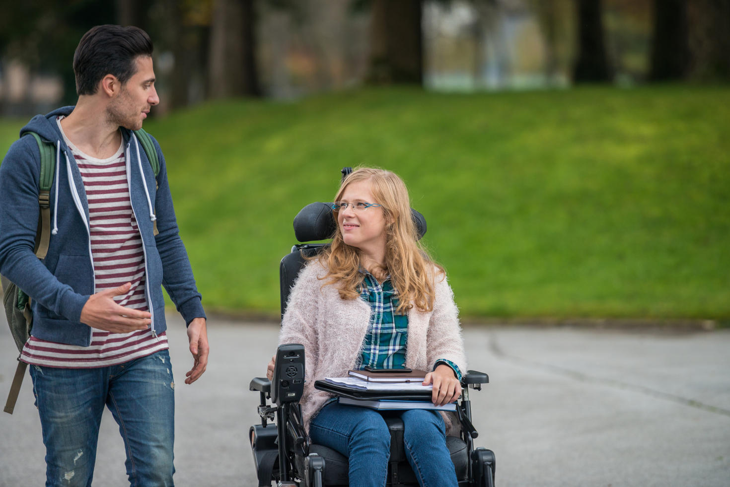 Student walking with a person in a wheelchair
