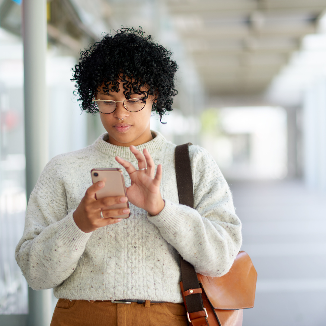 Woman walking while looking at phone