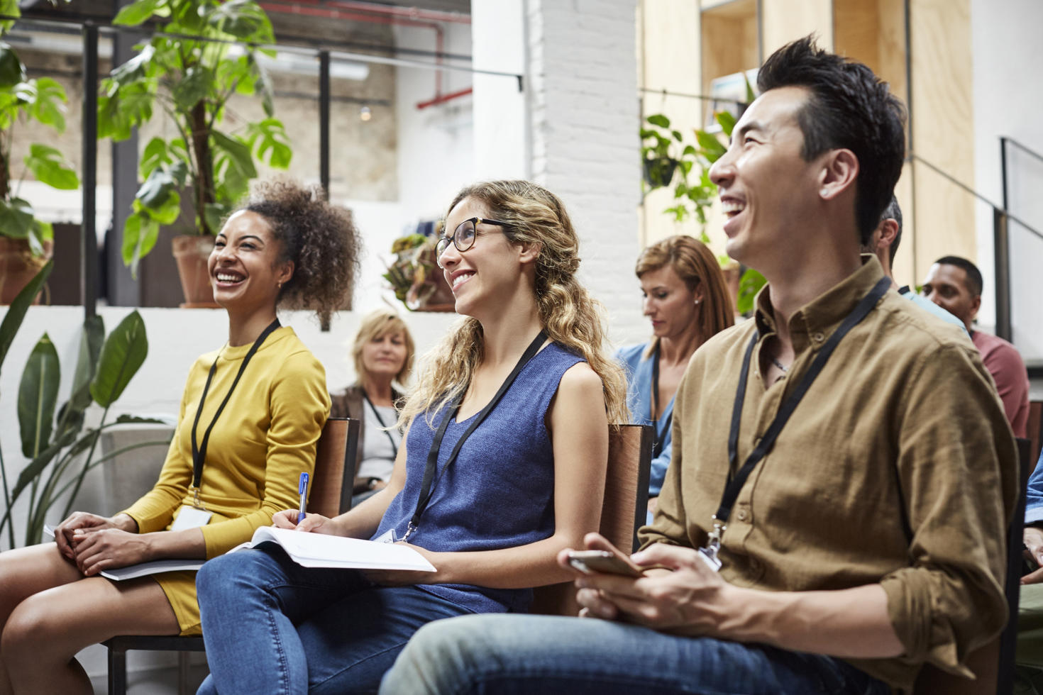 Employees smiling and looking at presentation