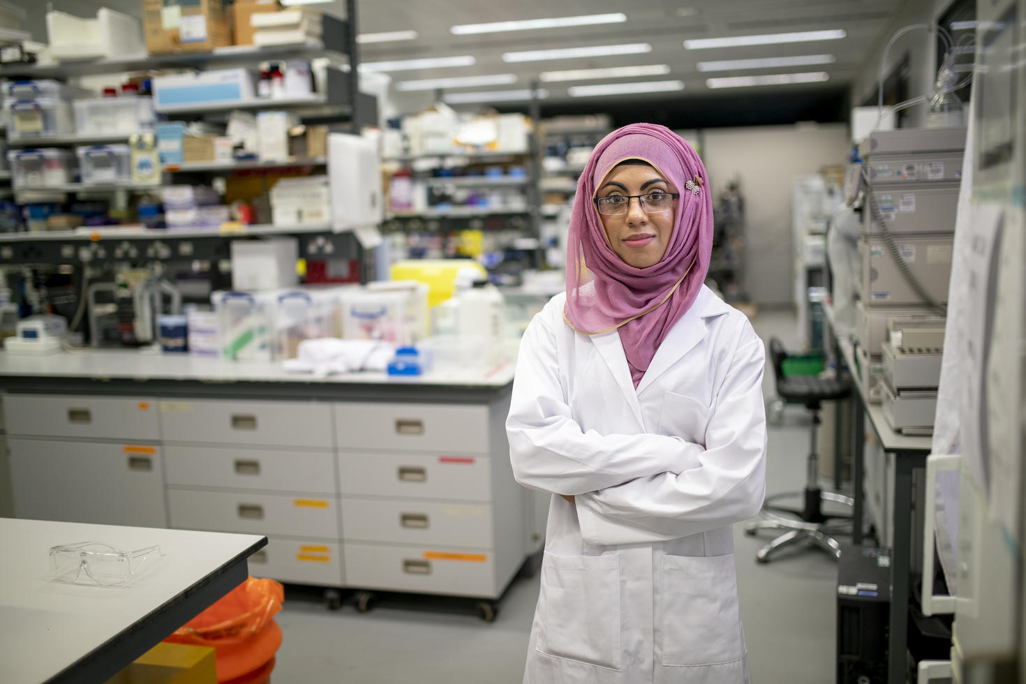 Research assitant standing in laboratory.