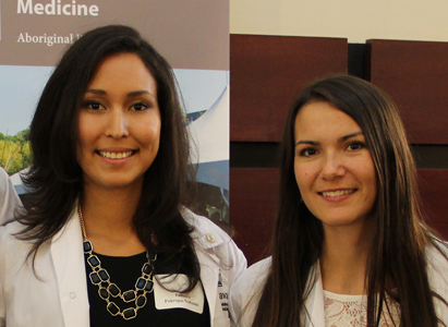 Image shows two women, both wearing white lab coats. 