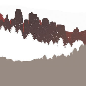 Skyline view of buildings, mountains and trees