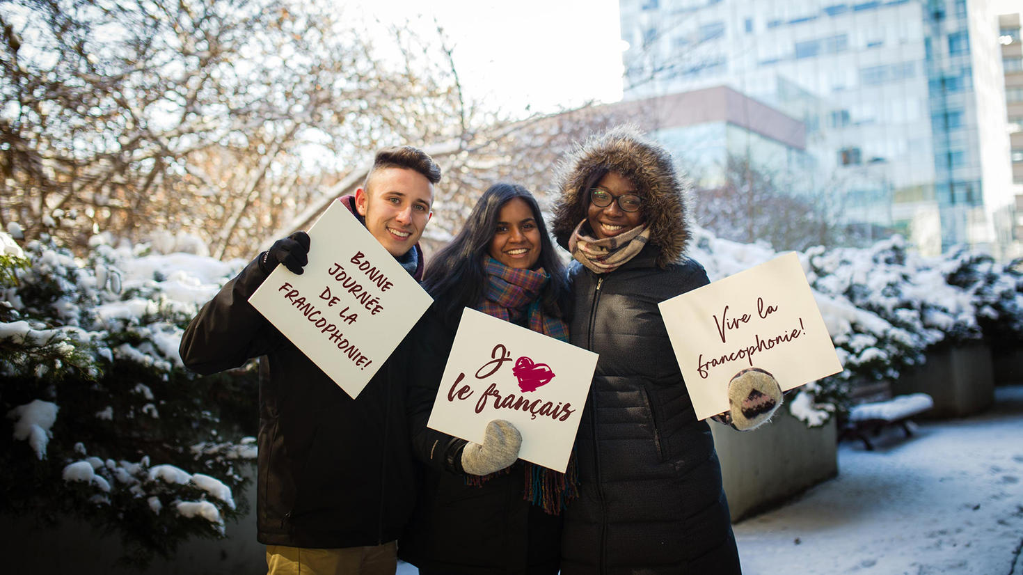 Students holding banners about Francophonie