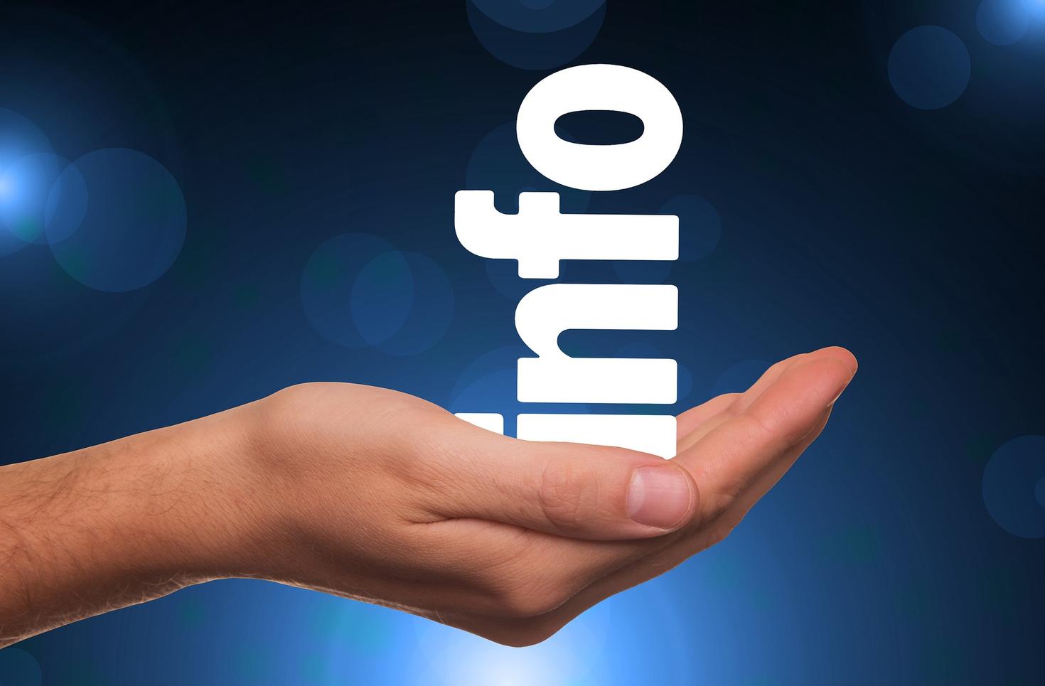 Hand holding letters that make up "info".