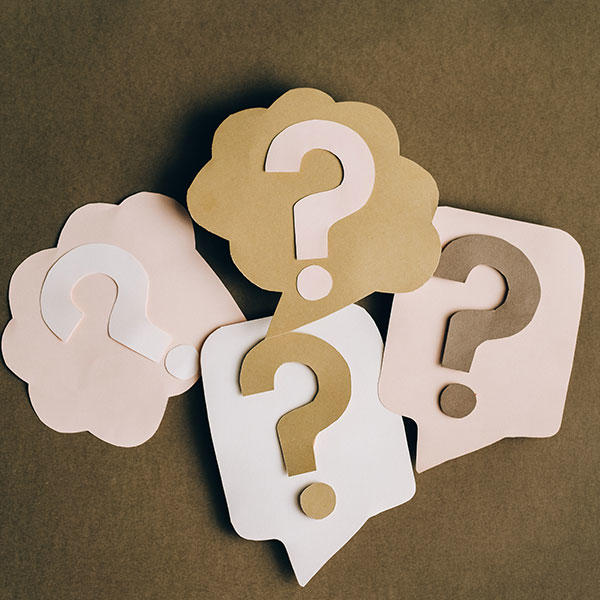 Cardboard cut out question marks.