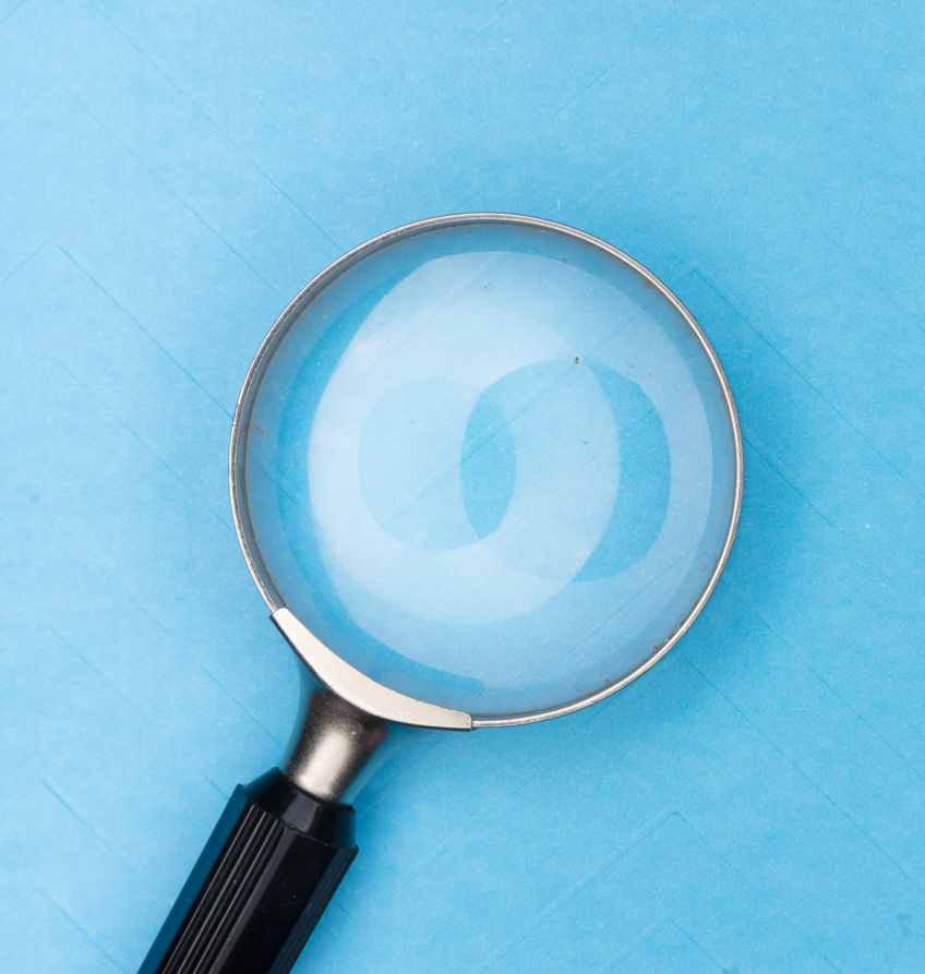 Magnifying glass over blue background.