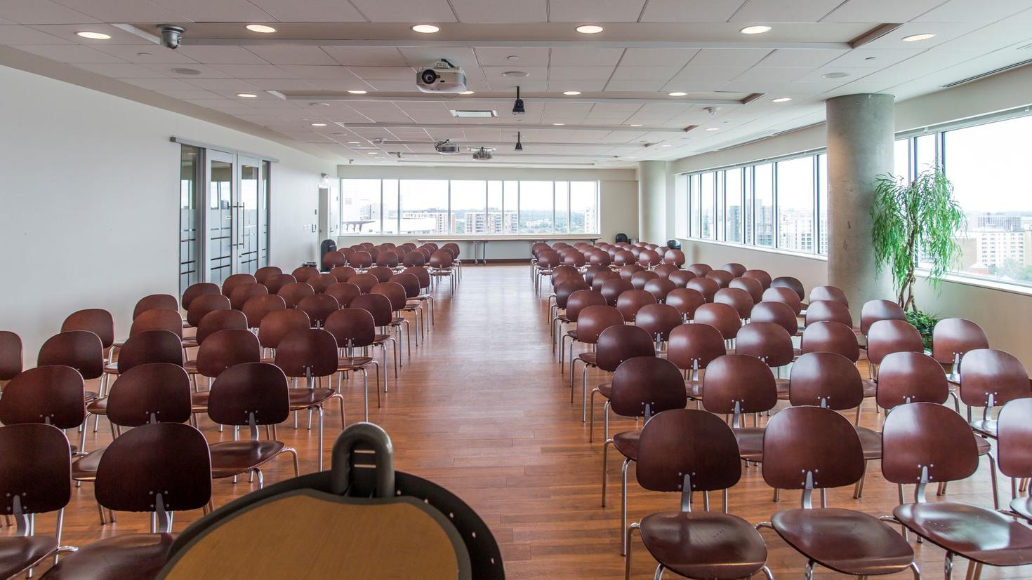 Podium view of empty chairs in Desmarais 12102.