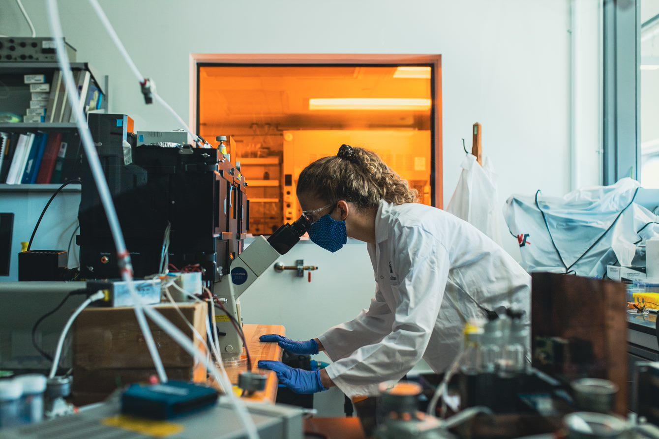 Researcher working on a microscope