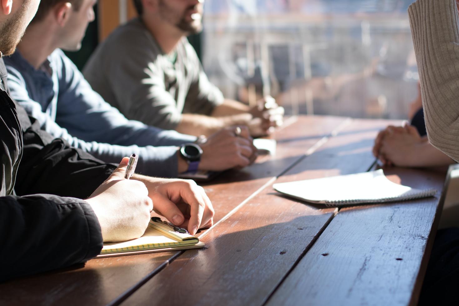 Group of people taking notes