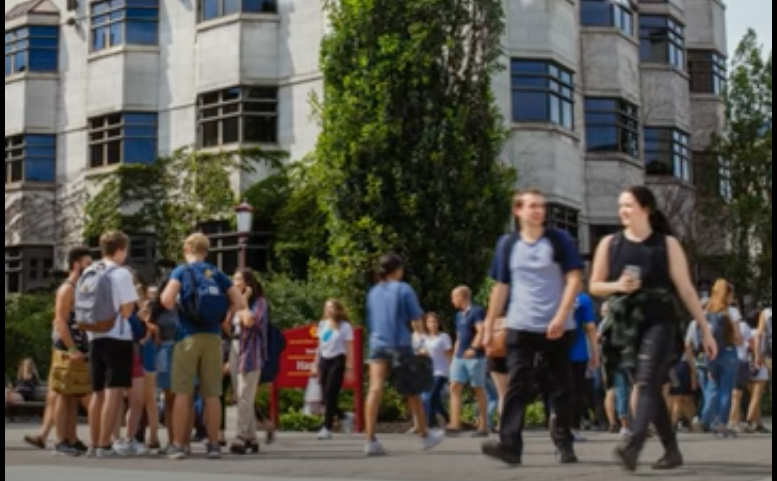 Screen capture of the video with students walking on campus