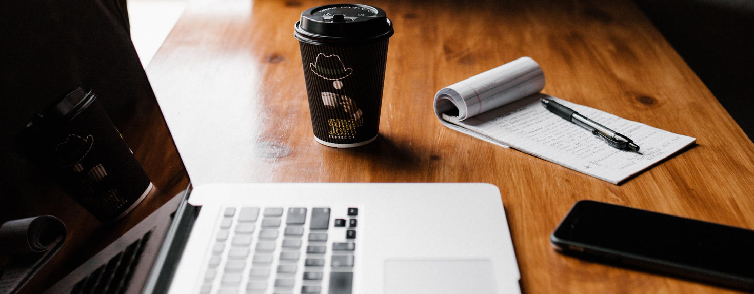 Laptop and coffee with notepad