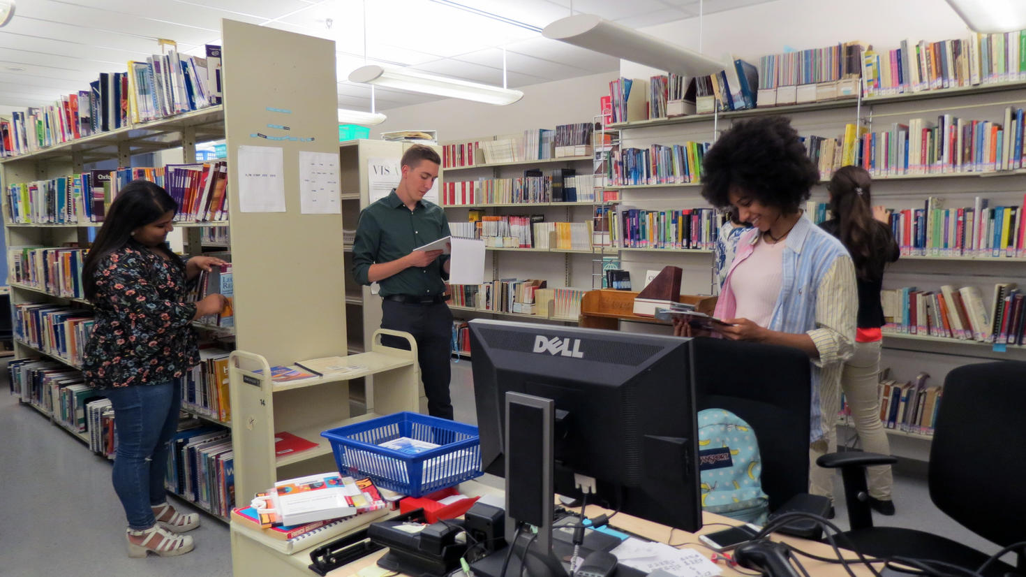 Students consulting the books at the Julien Couture Resource Centre