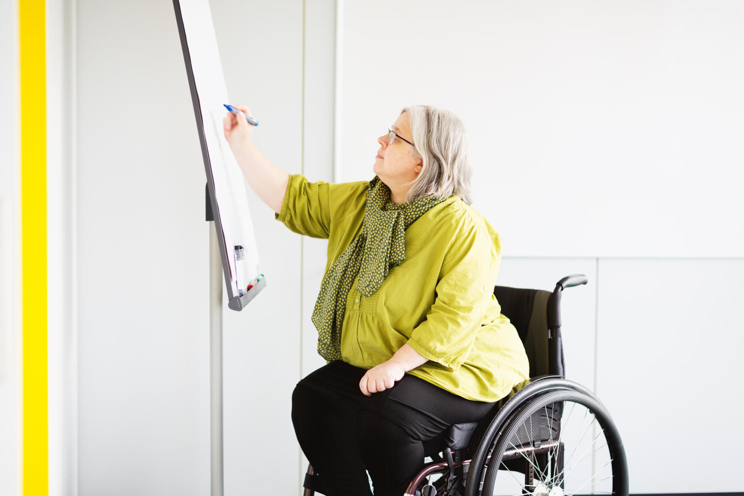 woman in a wheelchair working in office