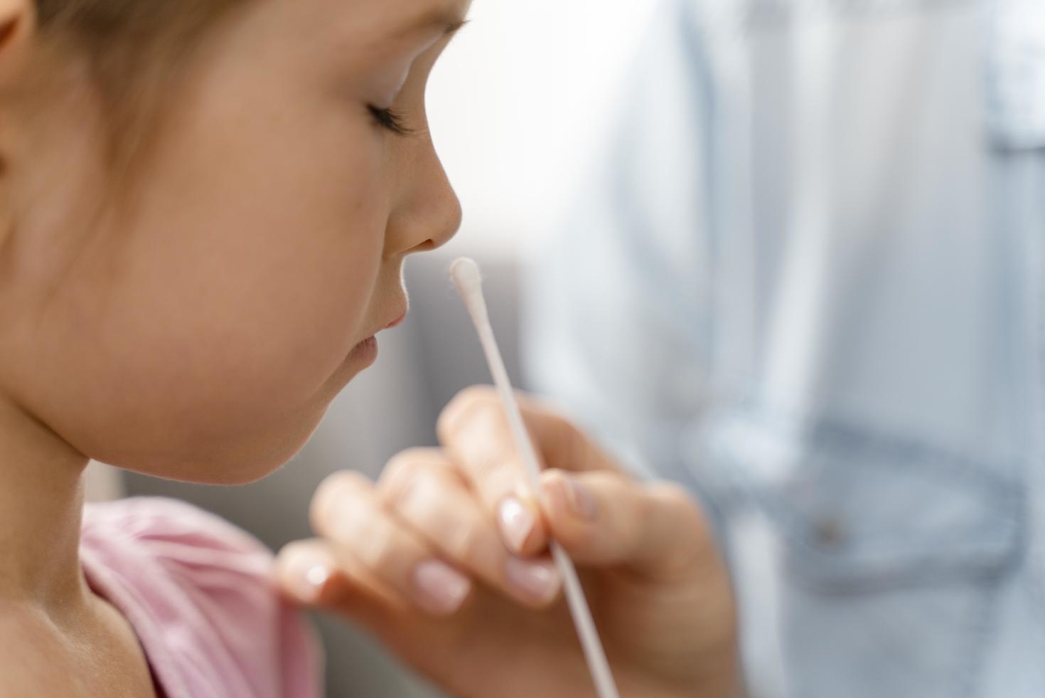 child getting nose swab