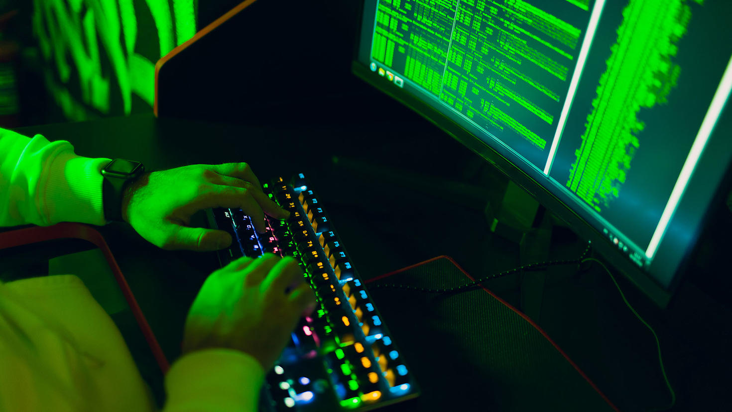 Close up of a keyboard and cyber criminal using computer malware.