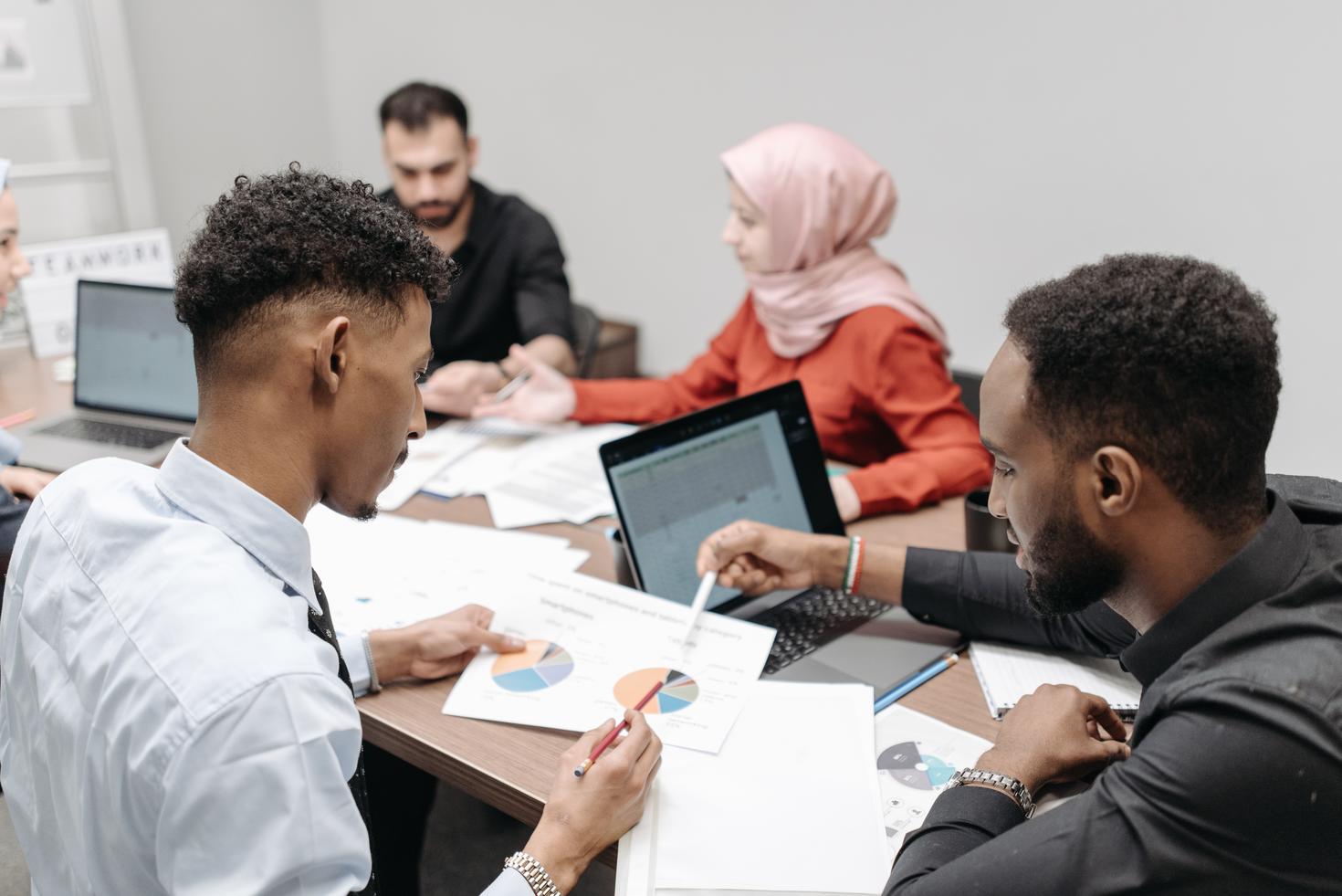 People reviewing reports at desk.