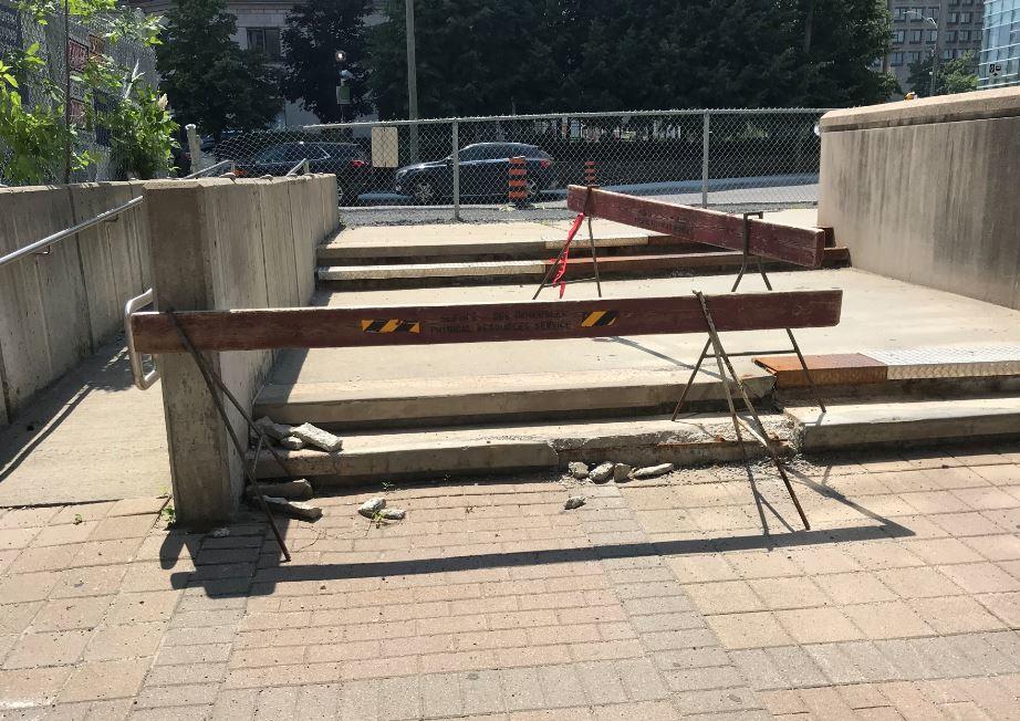 Broken staircase with barriers set up around it.