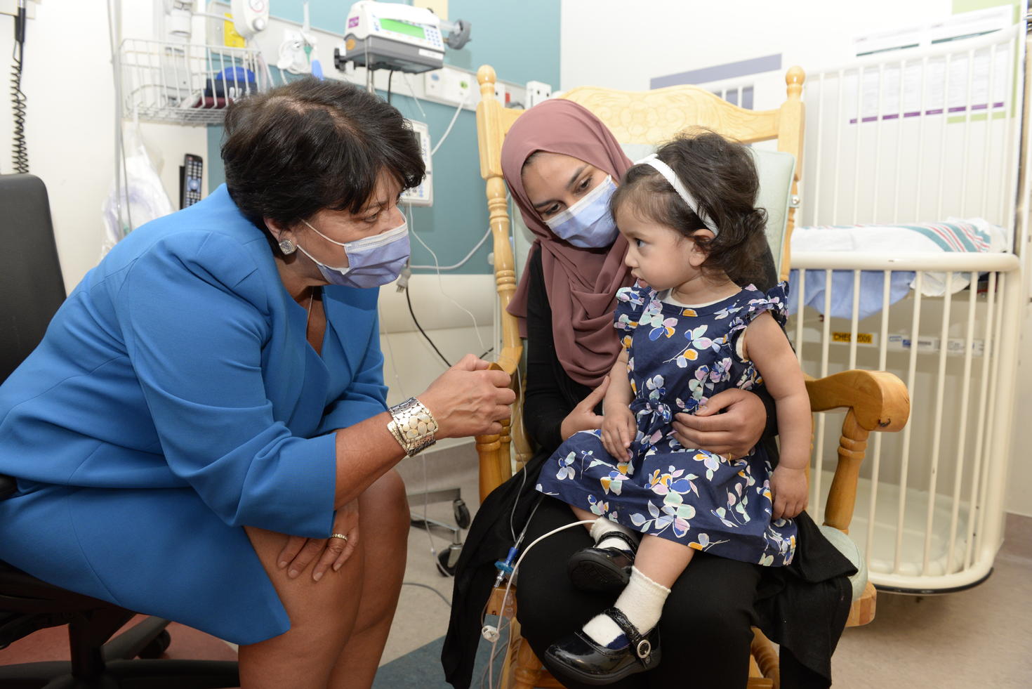 Karen Fung-Kee-Fung examining Ayla Bashir with her mother