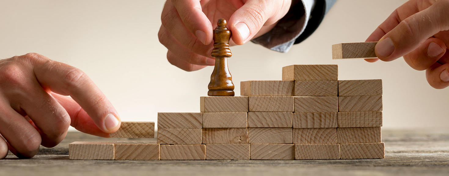 Representation of success created by a chess piece moving up a stair of blocs.