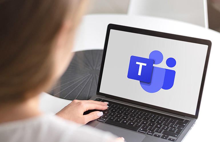 Laptop displaying Microsoft Teams logo.