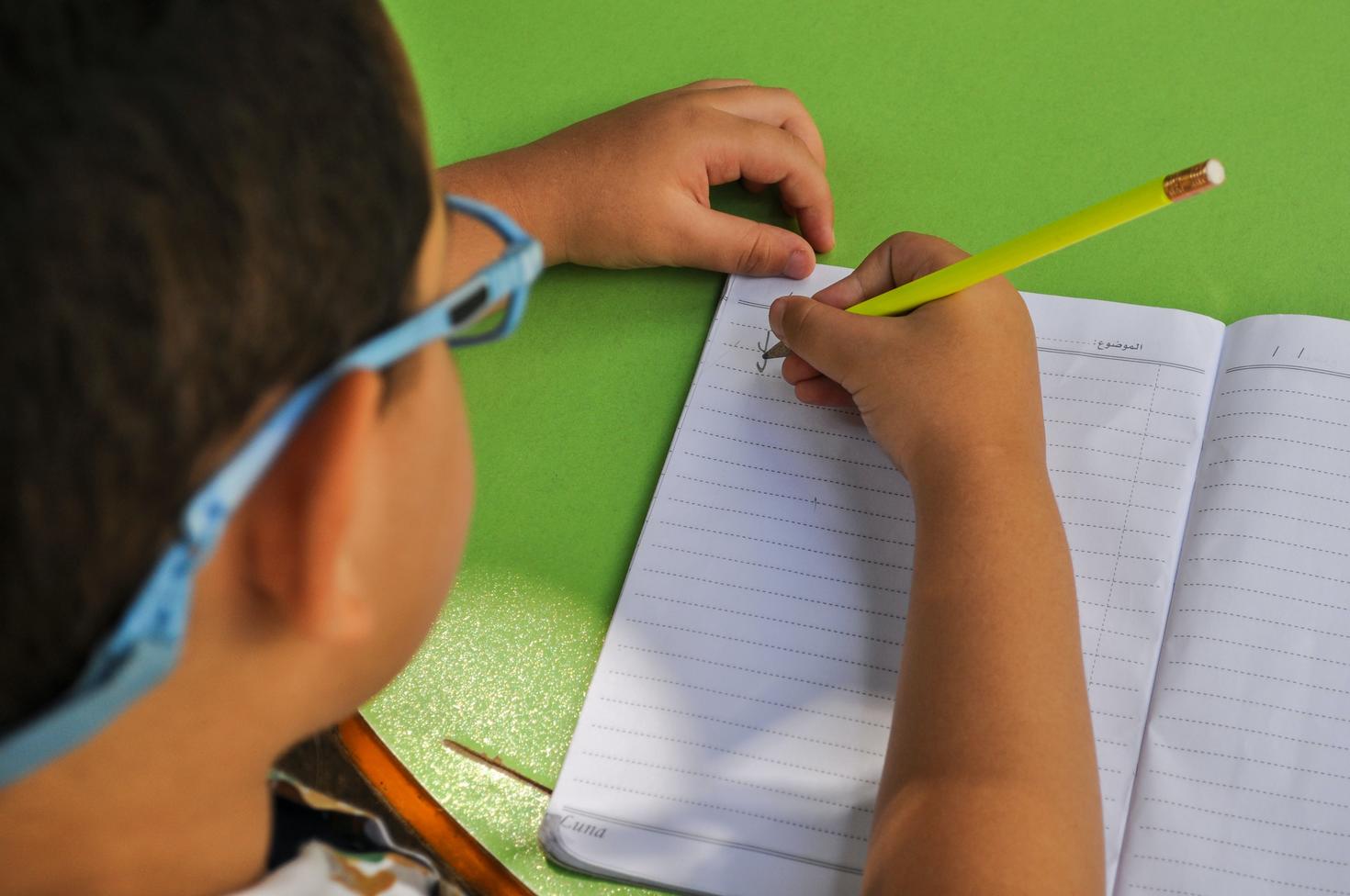 A child writing on a workbook