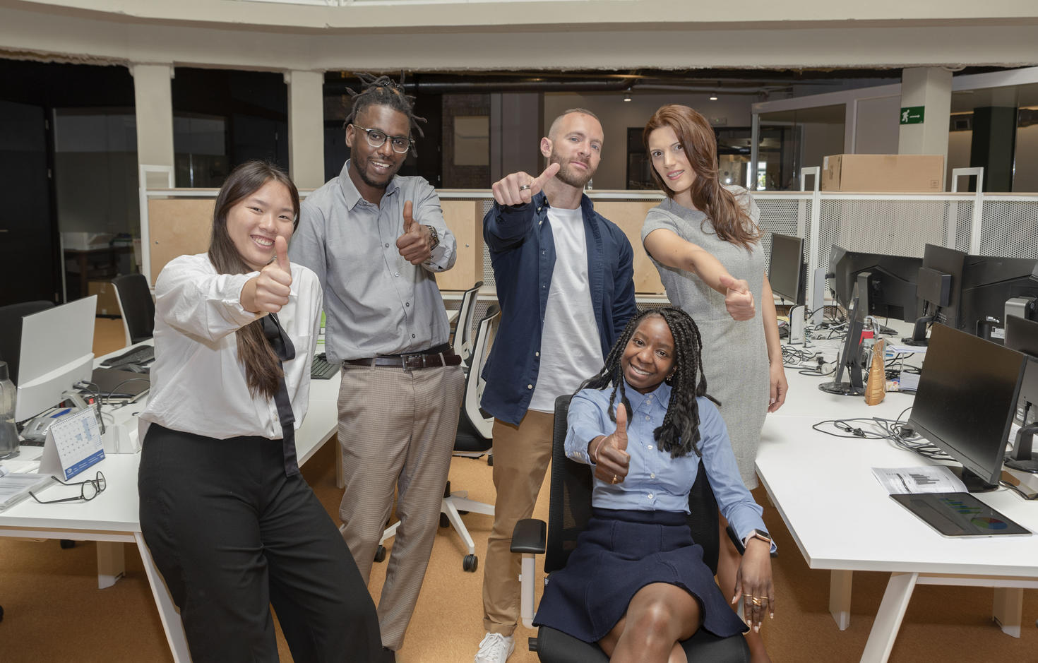 smiling people with a thumbs up.