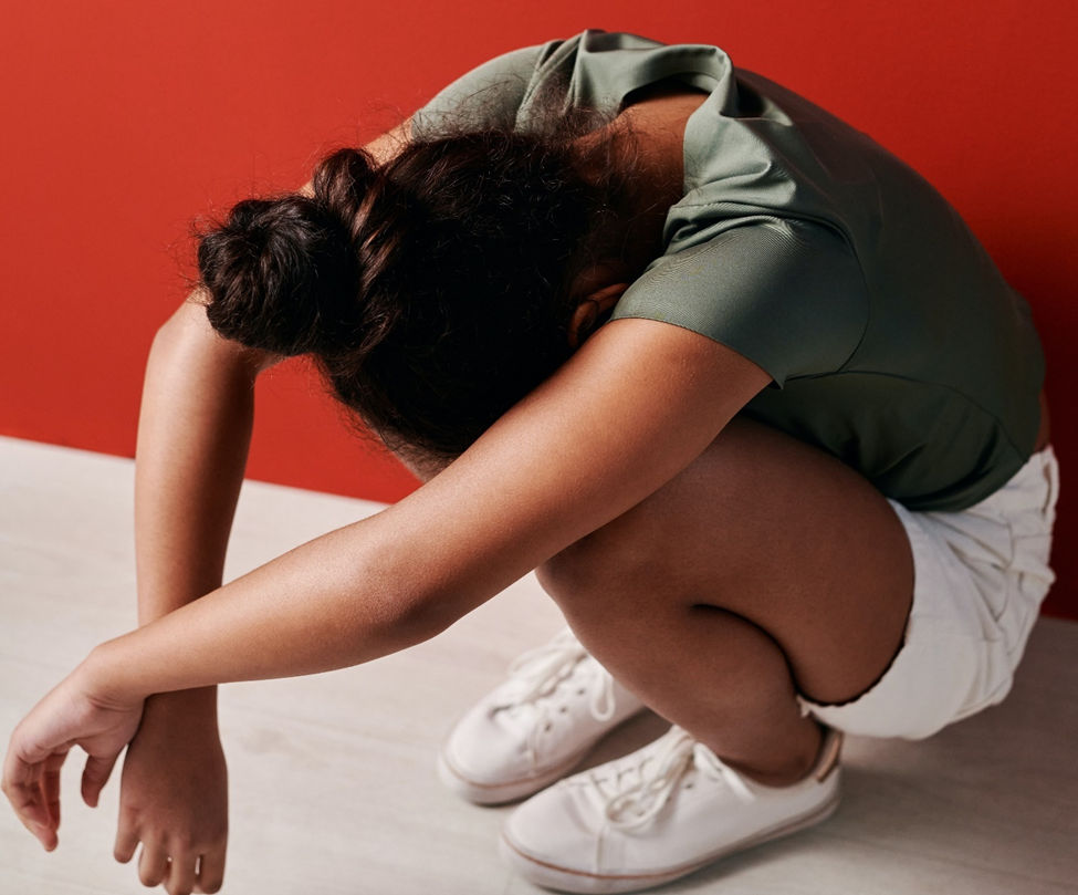 Young girl crumpled over