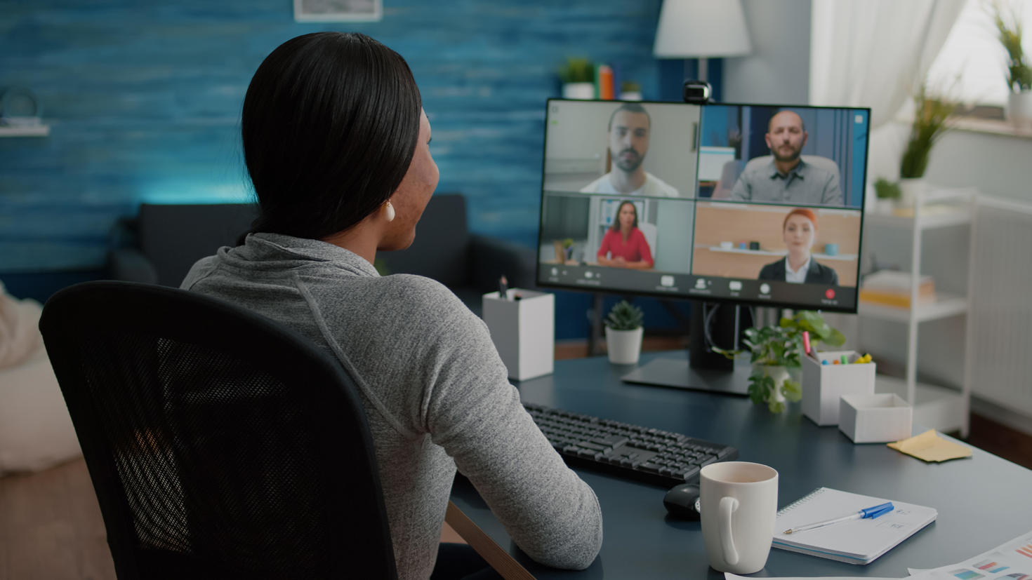 young women taking a virtual call with colleagues on a computer screen