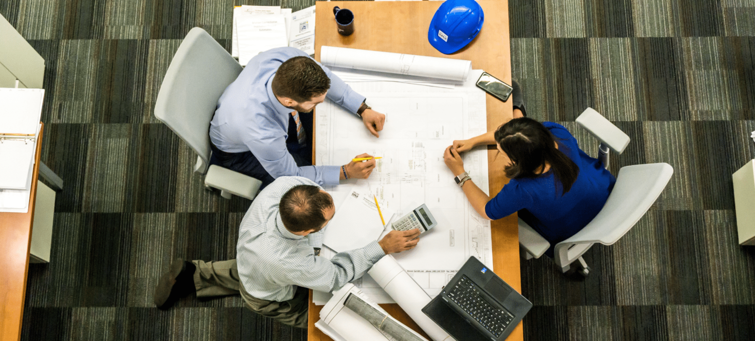 Team reviewing floor plans at a meeting table