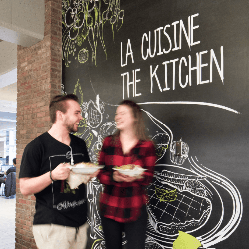 A university cafeteria with ‘la cuisine - the kitchen’ written on the wall