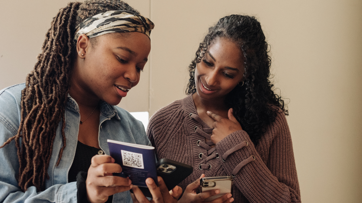 two girls looking at a phone
