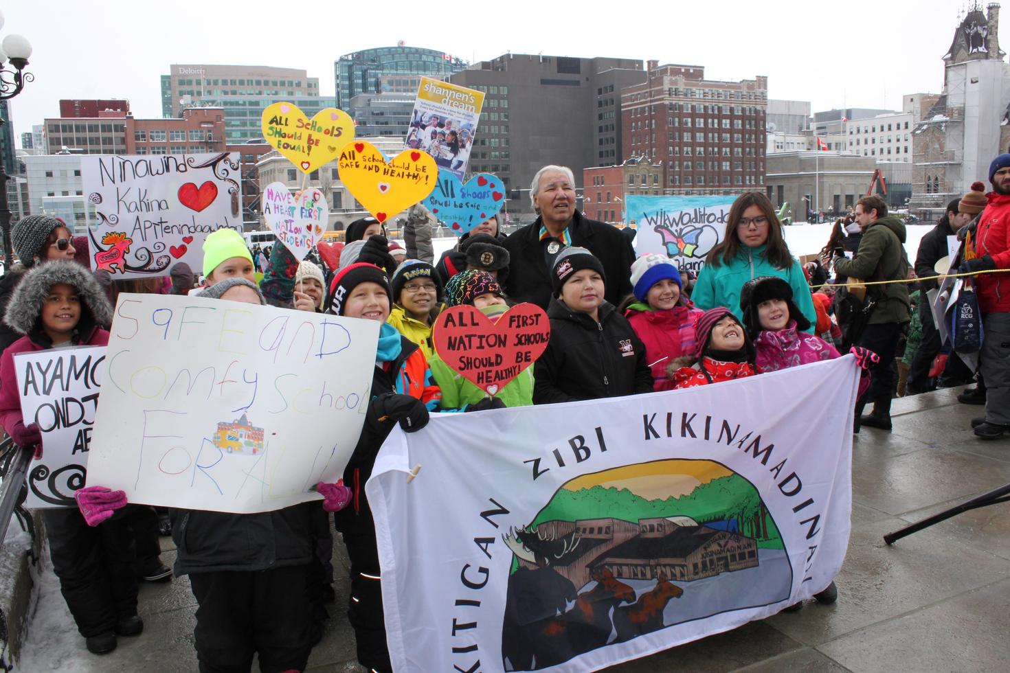 Students holding signs on Parliament Hill.