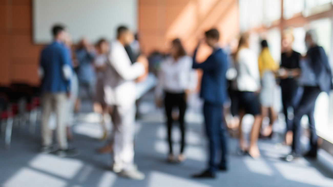 A blurry image of a group of people in a room.