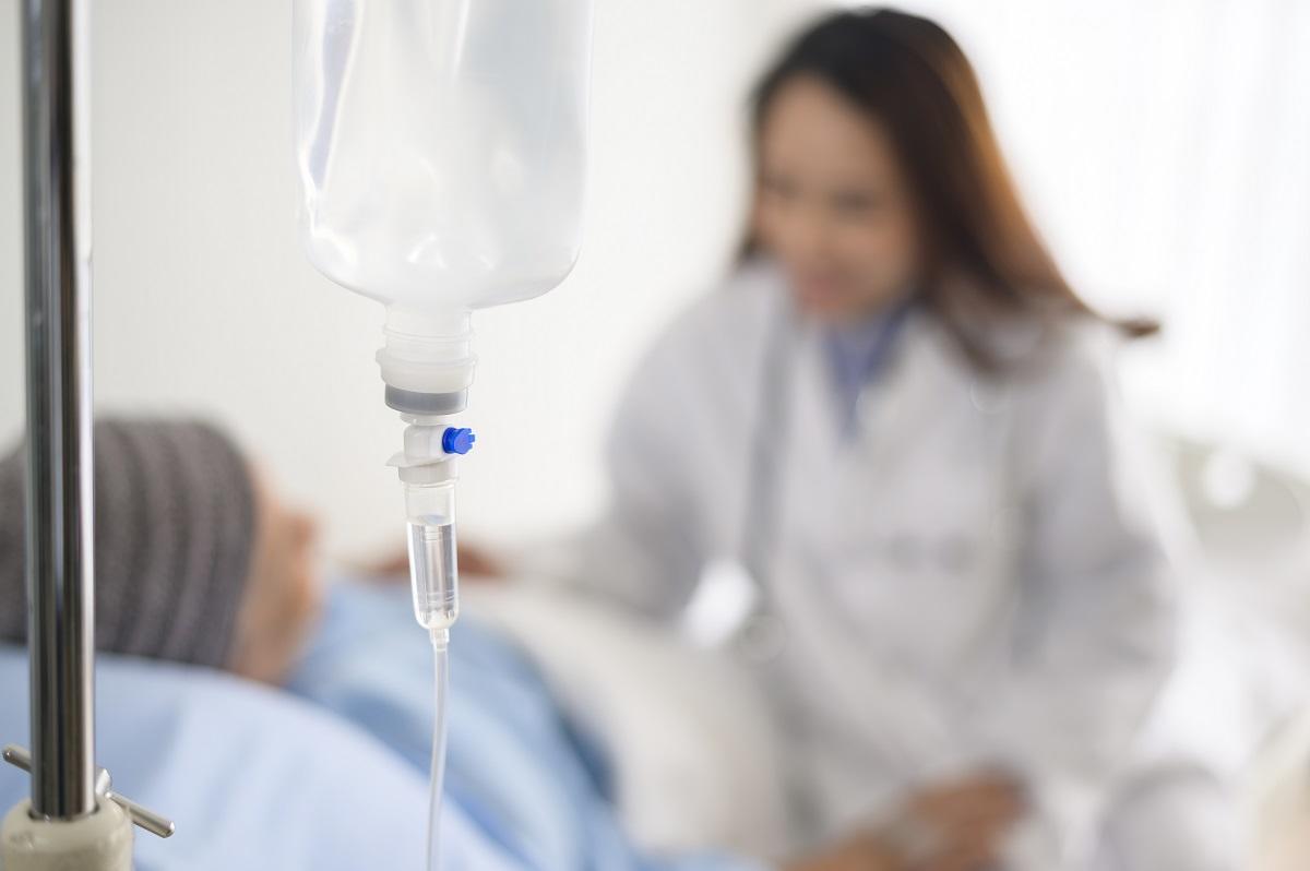 IV drip in focus in fron to doctor and patient