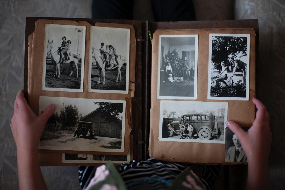 Person looking at black and white photos in an album