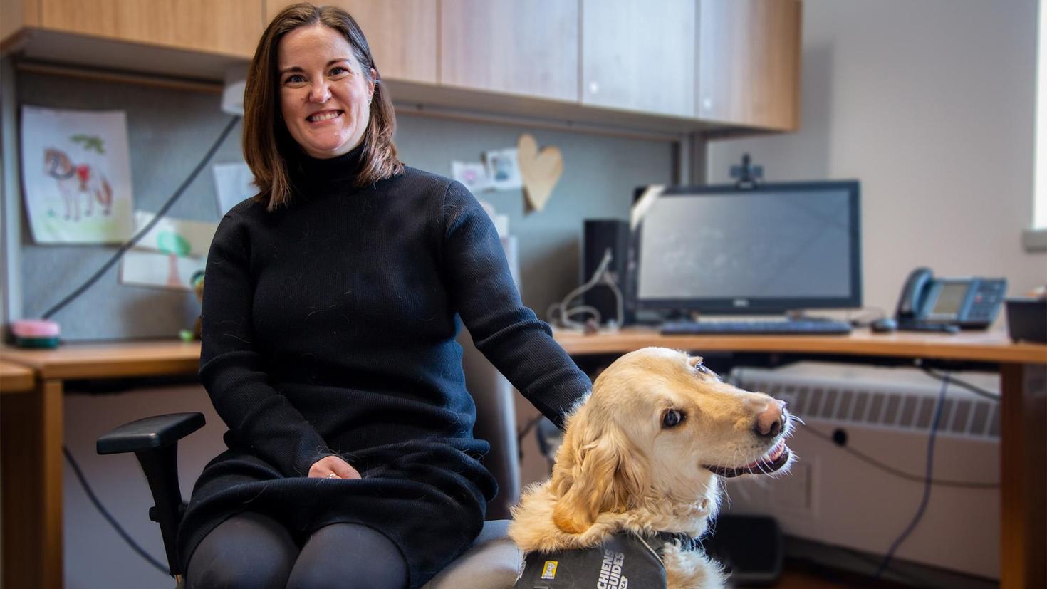 Erin Maloney with her service dog, Winston at her uOttawa office