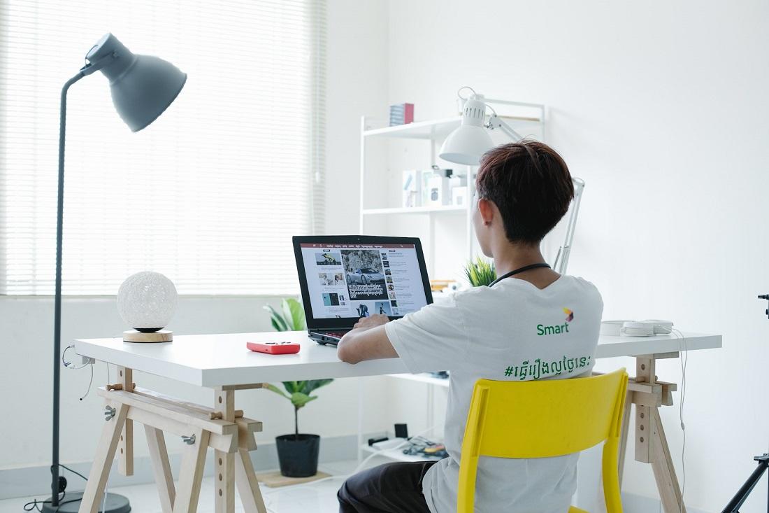 Back view of young teen surfing web